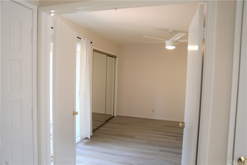 8462 Basin Circle Huntington Beach, CA 92646 - Photo 24 of 29 a view of a hallway with wooden floor