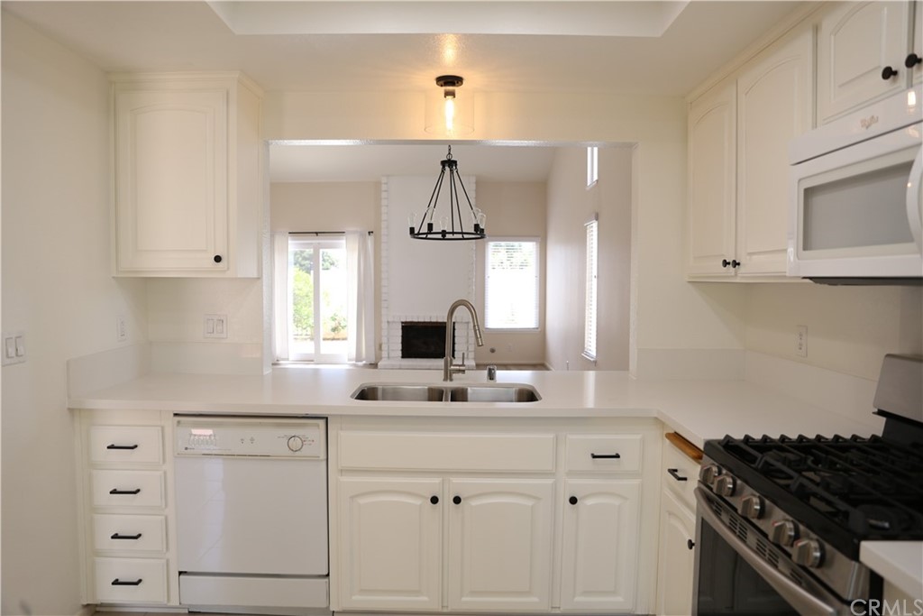 8462 Basin Circle Huntington Beach, CA 92646 - Photo 8 of 29 a kitchen with white cabinets and a stove