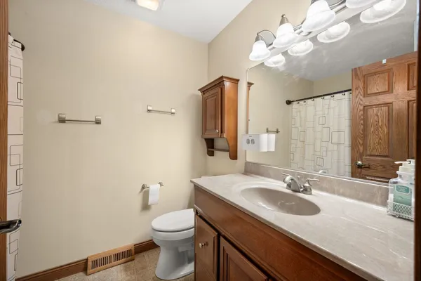 a bathroom with a sink a toilet and a mirror