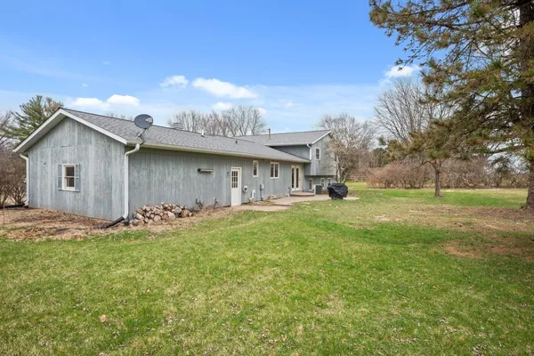 a view of house with yard and green space