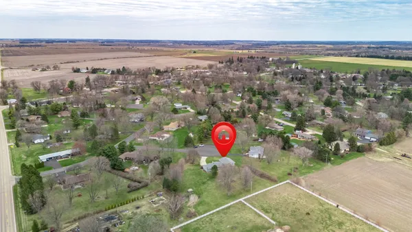 an aerial view of a house with a yard