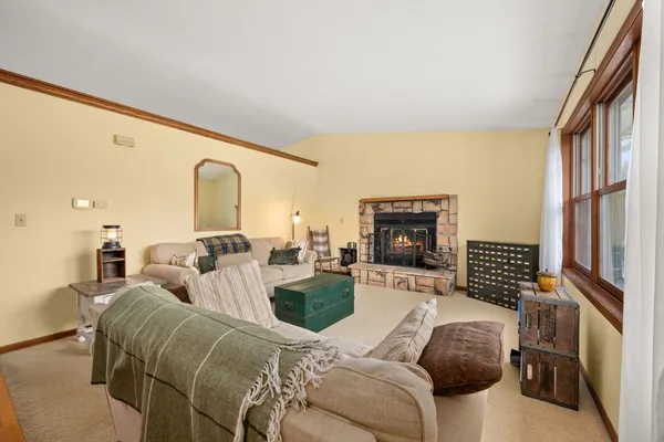 a living room with furniture a fireplace and a flat screen tv