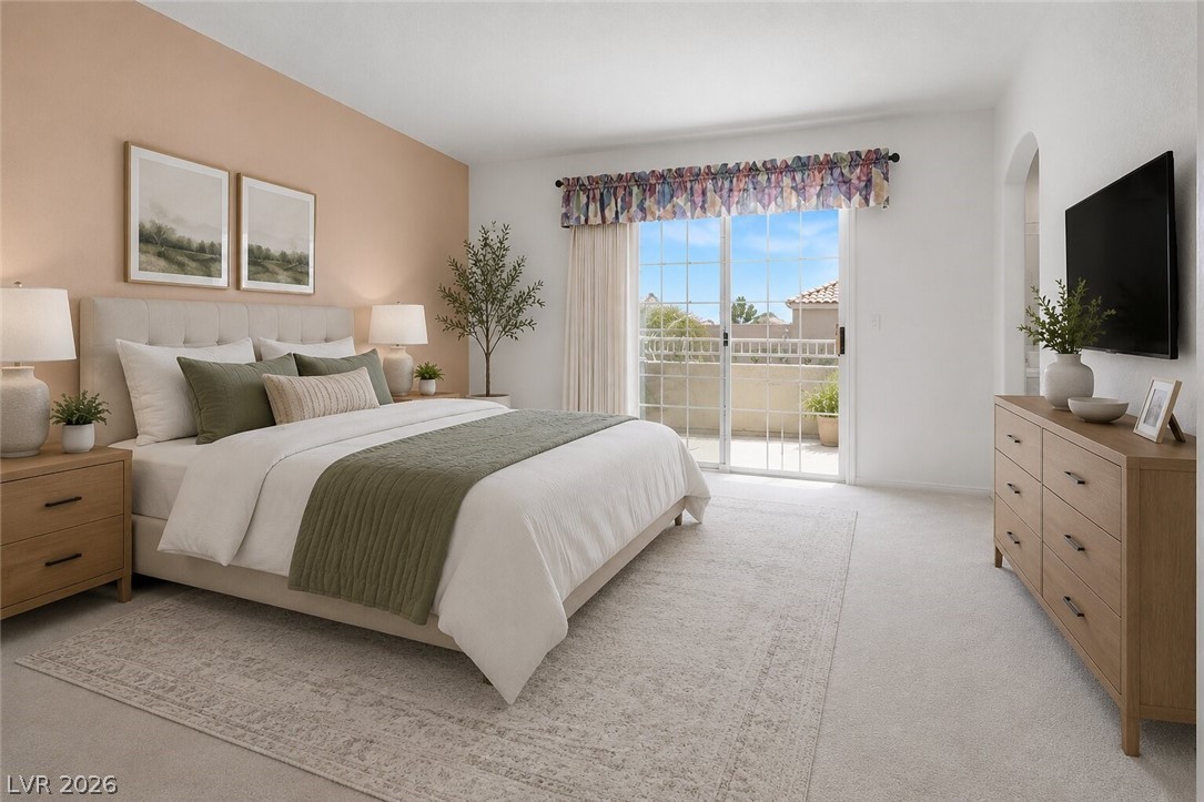 2243 Rugged Mesa Drive Laughlin, NV 89029 - Photo 15 of 32 Well-lit primary bedroom featuring soft carpeting and direct access to an outdoor space.
