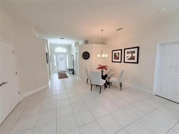 an empty room with furniture and a large window