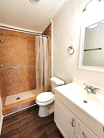 a view of a room with wooden floor and cabinet