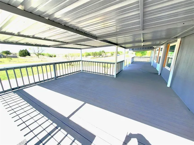 a view of a balcony with wooden floor