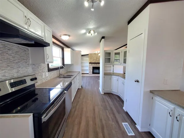 a kitchen with stainless steel appliances granite countertop a sink and a microwave