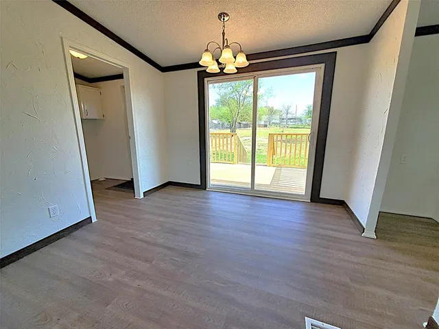 a view of a livingroom with wooden floor and a ceiling fan