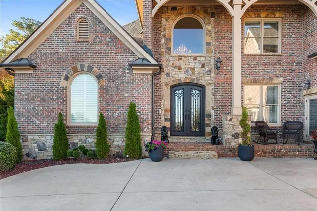 a front view of a house with a garden