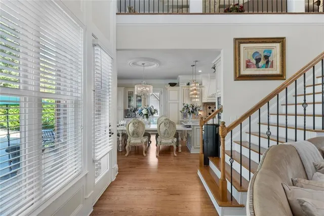 a living room with furniture and a chandelier