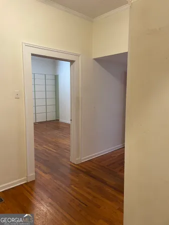 an empty room with wooden floor