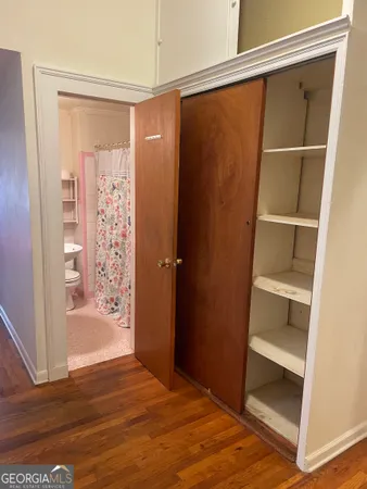 a view of an empty room and wooden floor
