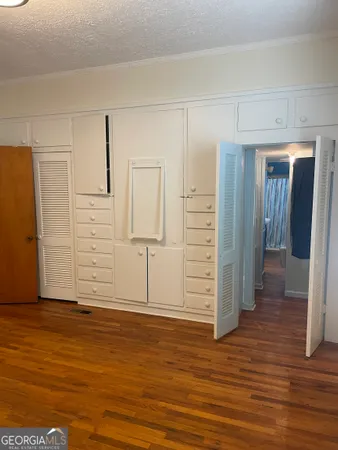 a view of a room with wooden floor and closet