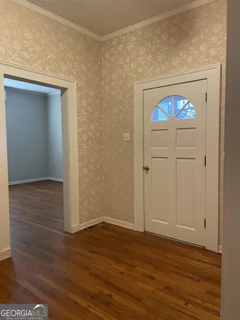 a bathroom with a sink a mirror and wooden floor