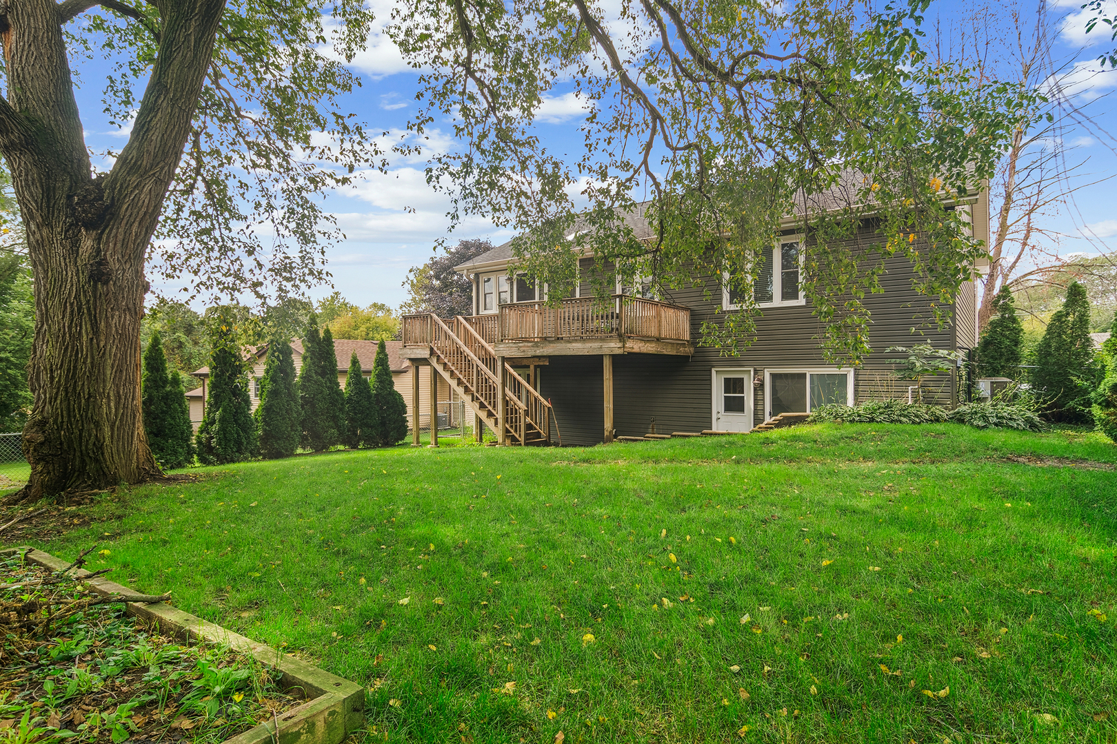 6316 Hilly Way Cary, IL 60013 - Photo 4 of 27 a view of a big yard with plants and large trees