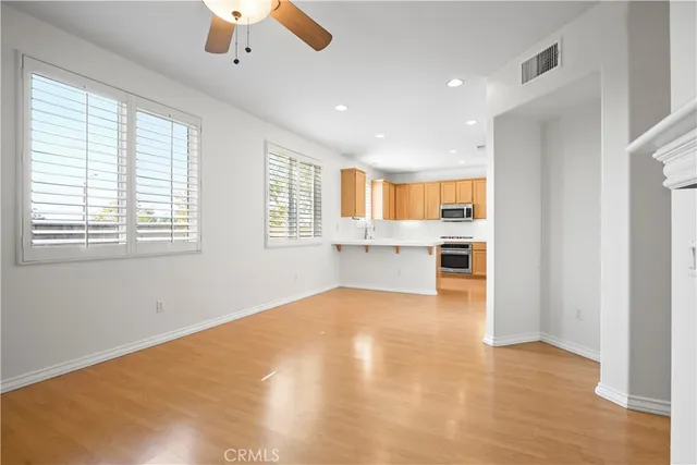 a view of an empty room with a kitchen