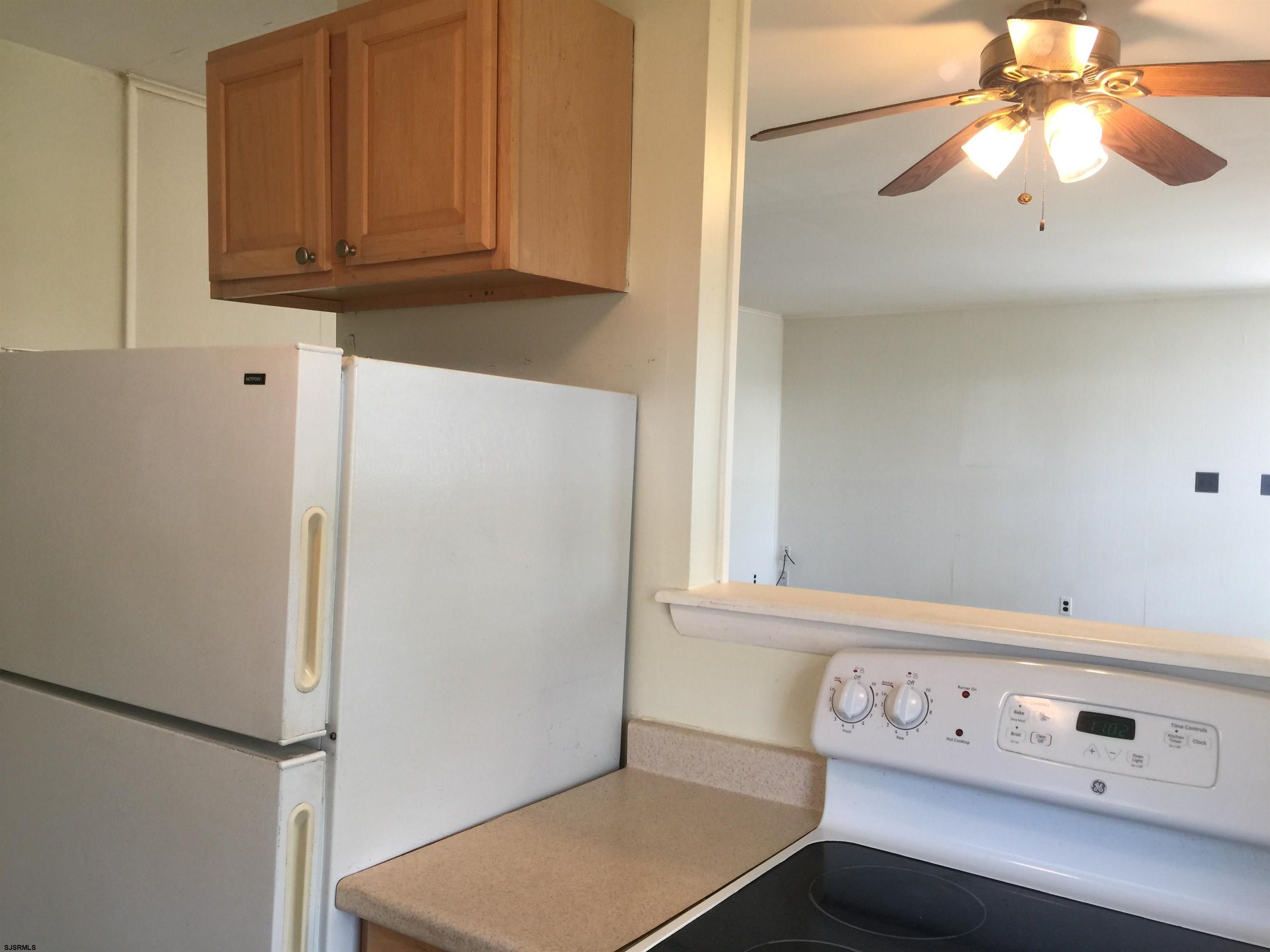 4632 Schooner Road, Unit 1 Brigantine, NJ 08203 - Photo 4 of 16 a view of cabinets with wooden floor