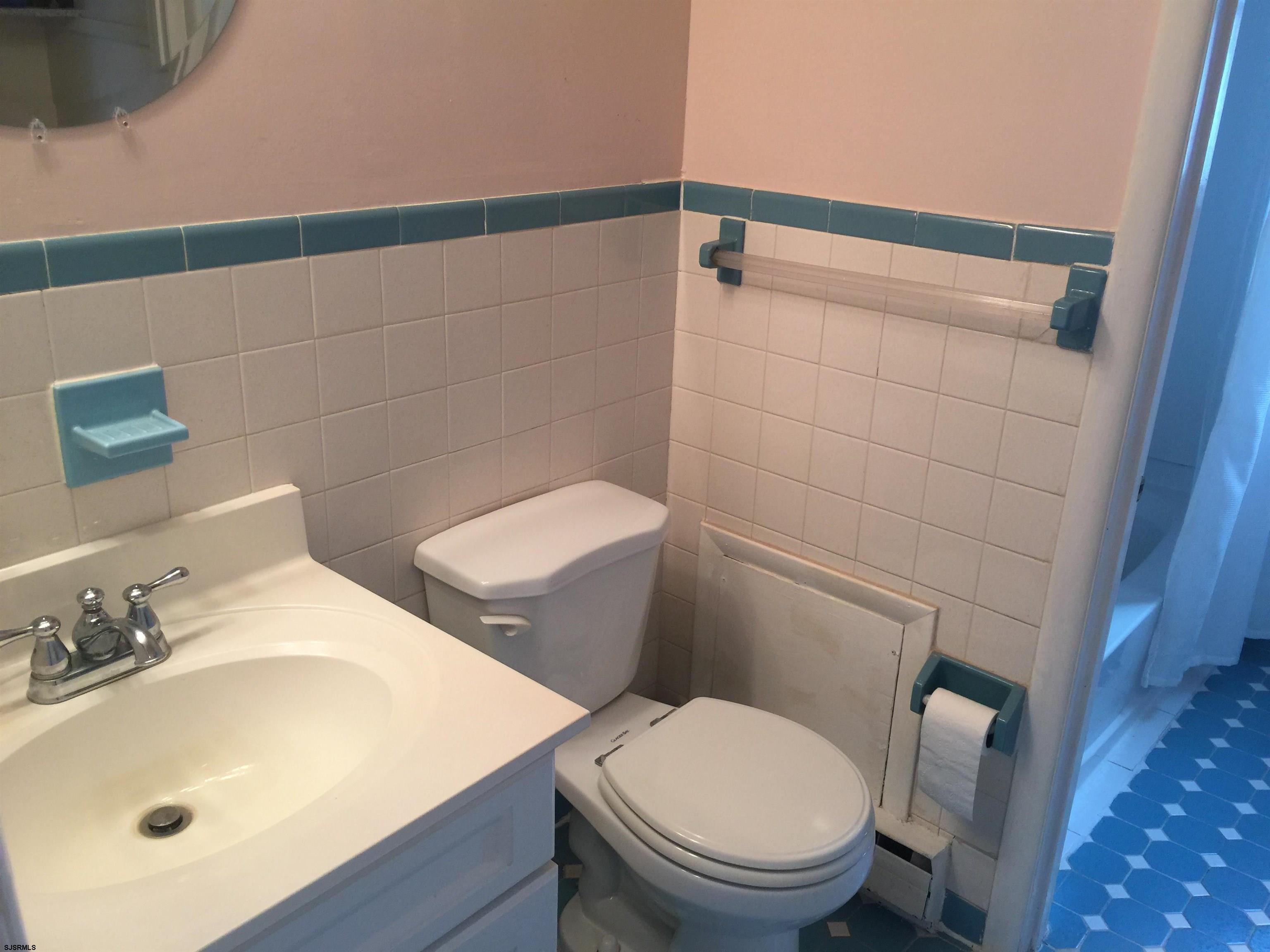 4632 Schooner Road, Unit 1 Brigantine, NJ 08203 - Photo 7 of 16 a white toilet sitting next to a bathroom sink