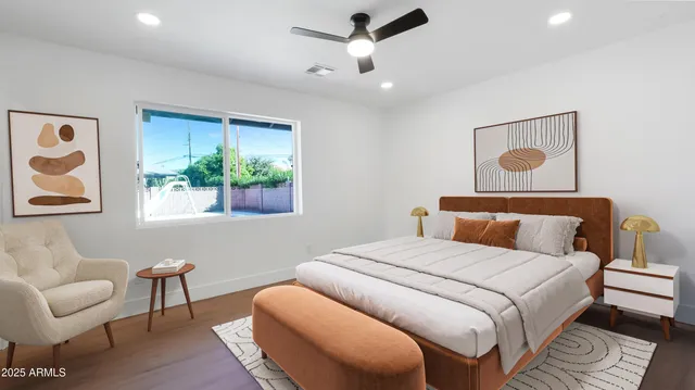 a bedroom with a bed and wooden floor