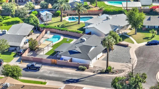 an aerial view of a house with yard swimming pool and outdoor seating