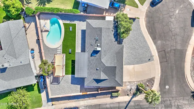 an aerial view of a house with a swimming pool