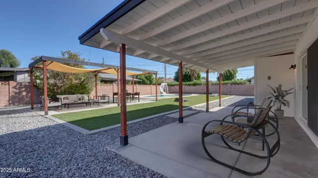 a view of a backyard with sitting area