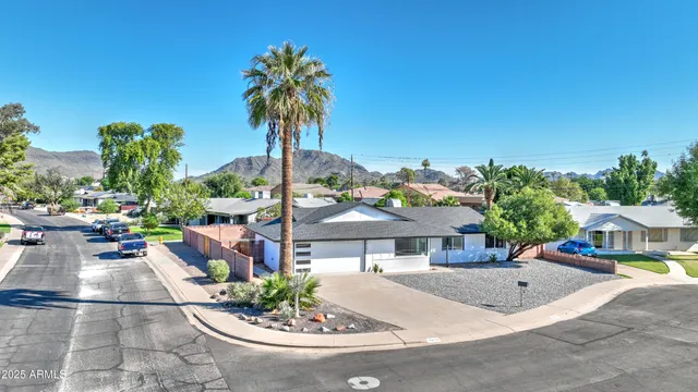 a view of a house with a small yard and potted plants