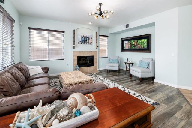 a living room with furniture ceiling fan and a window