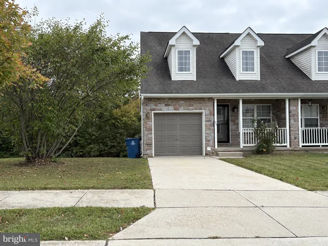 a house that has a tree in front of the house