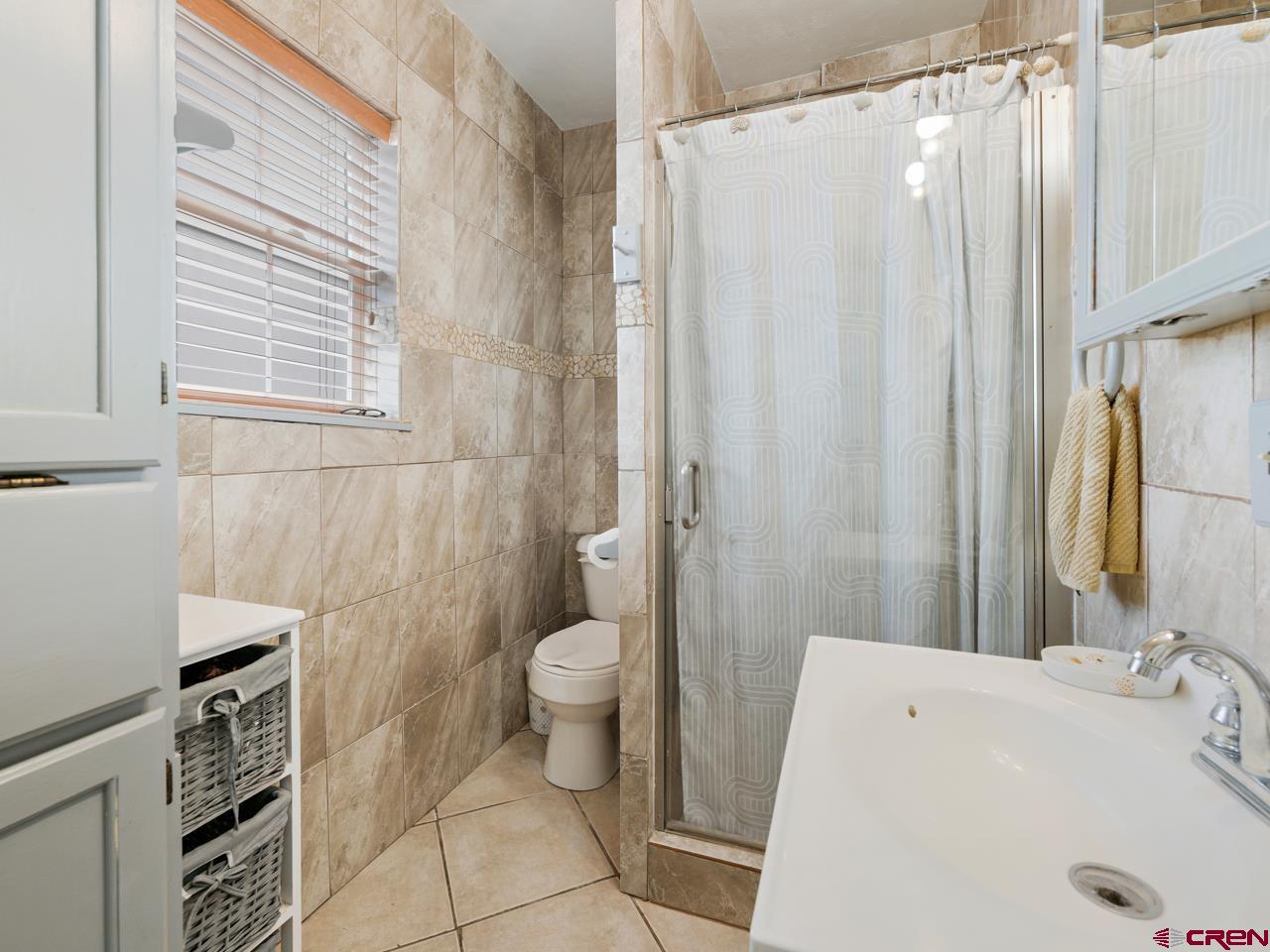 20809 Nowhere Road Eckert, CO 81418 - Photo 31 of 45 a bathroom with a sink toilet and shower