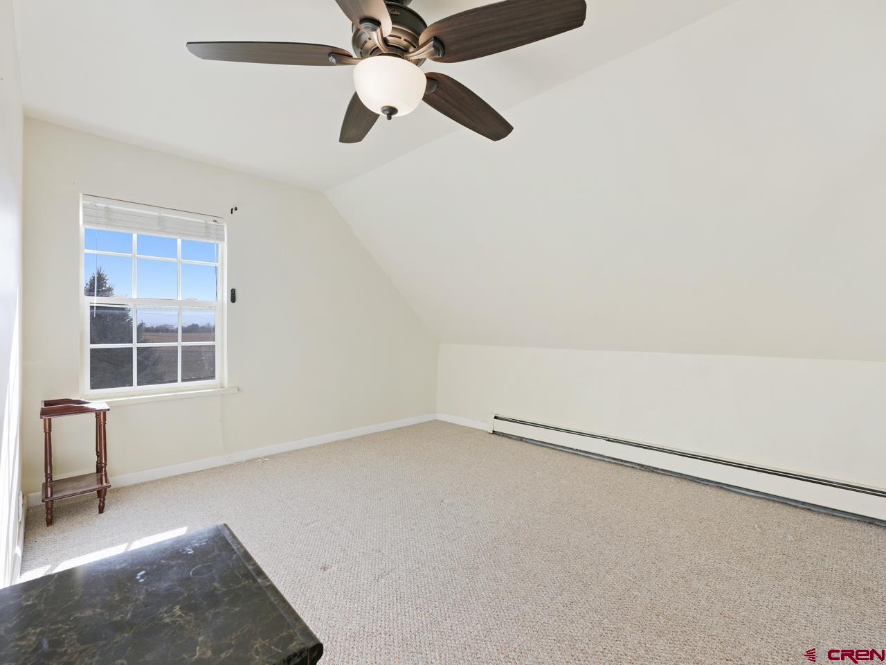 20809 Nowhere Road Eckert, CO 81418 - Photo 38 of 45 an empty room with windows and fan