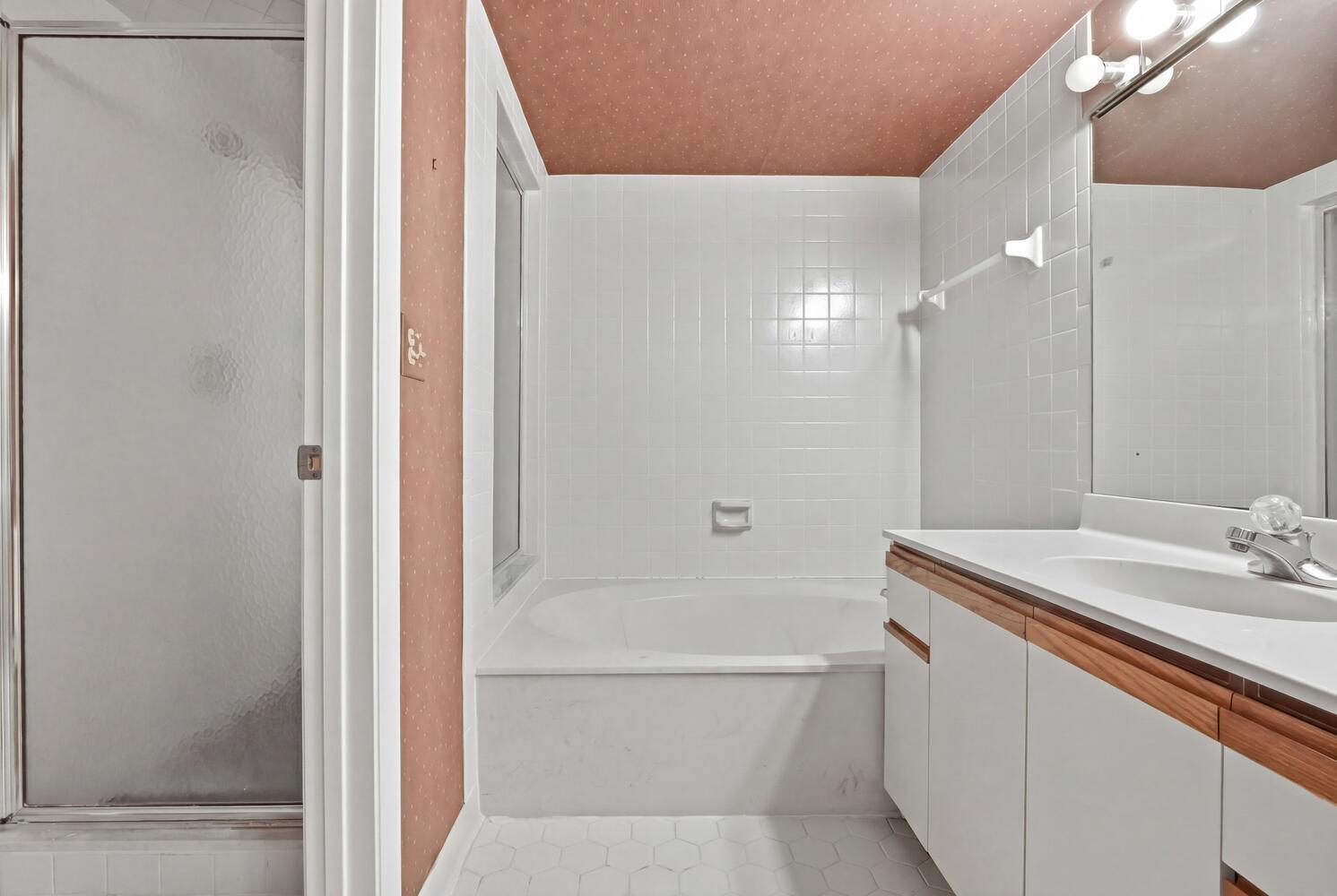 500 Ocean Trail Way, Unit 111 Jupiter, FL 33477 - Photo 14 of 35 a bathroom with a sink a toilet and shower