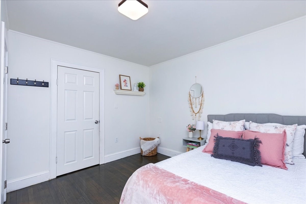 2 Summer Street North Reading, MA 01864 - Photo 23 of 42 a bedroom with a bed and a chandelier
