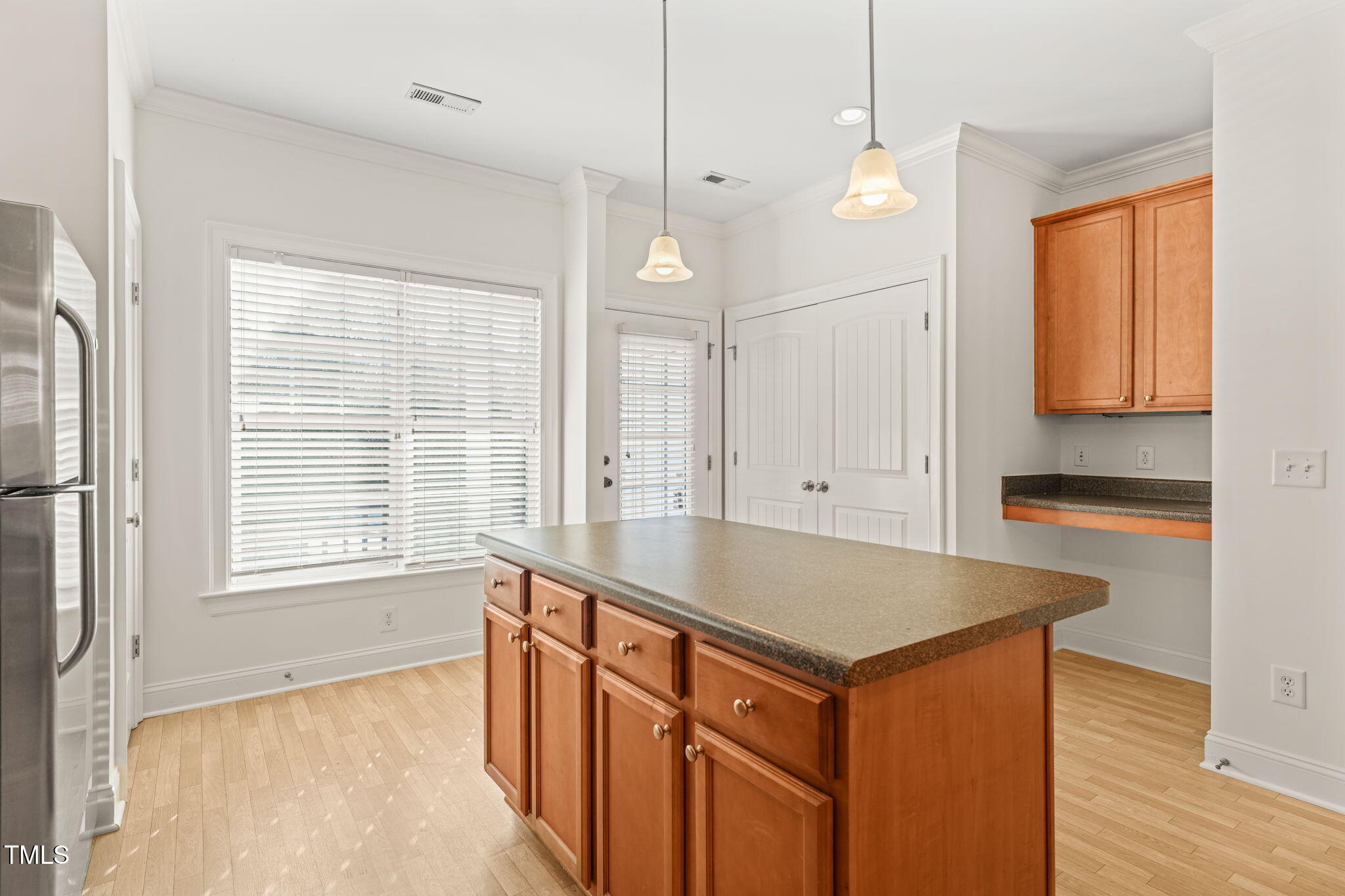 7732 ACC Boulevard Raleigh, NC 27617 - Photo 9 of 32 a kitchen that has a sink a window and a counter top space in it