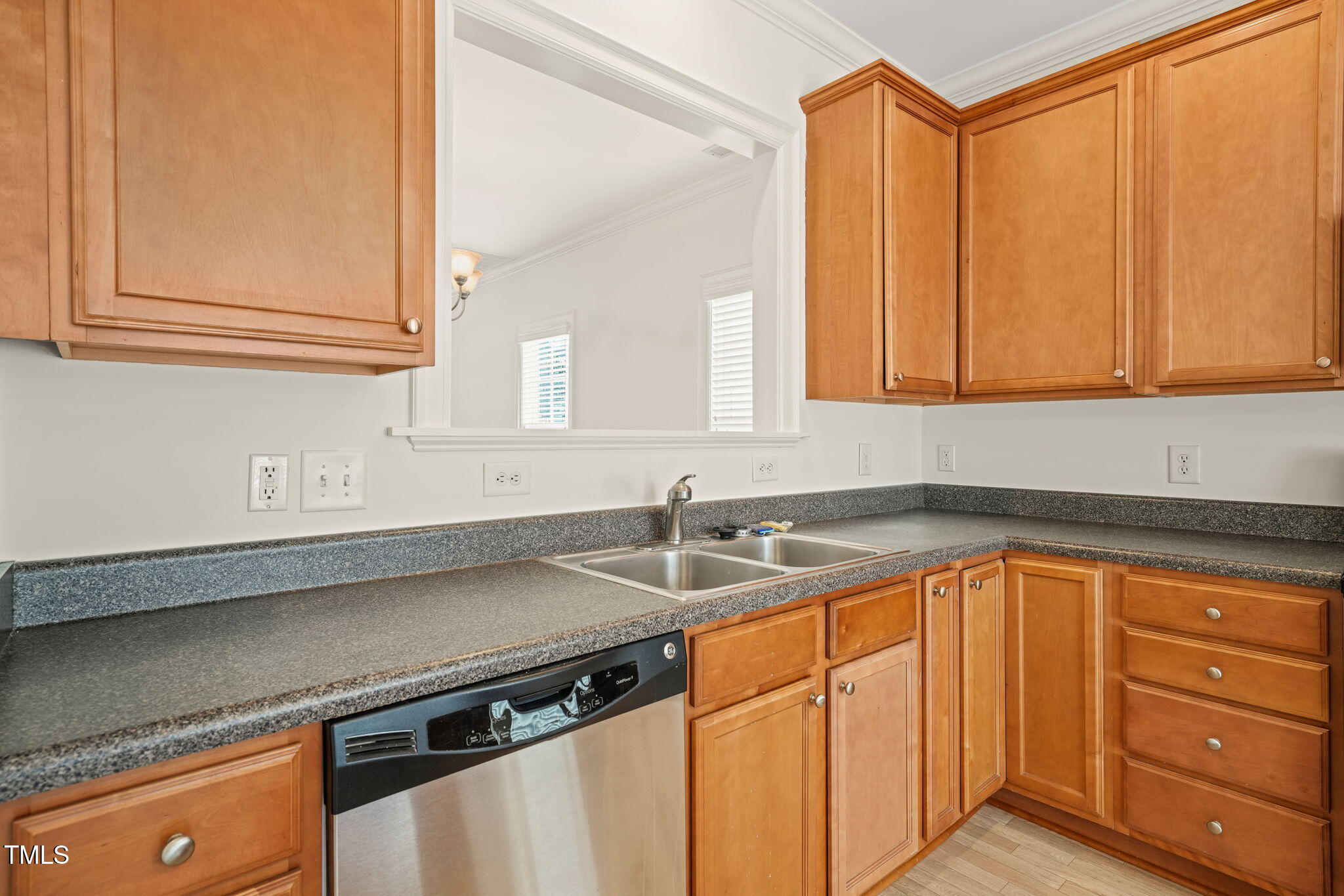 7732 ACC Boulevard Raleigh, NC 27617 - Photo 10 of 32 a kitchen with granite countertop stainless steel appliances a sink window and cabinets