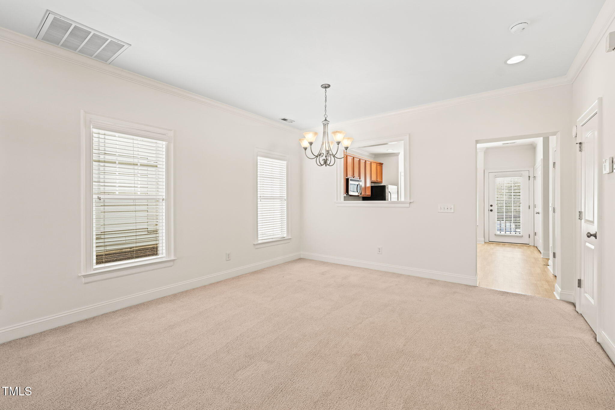 7732 ACC Boulevard Raleigh, NC 27617 - Photo 14 of 32 an empty room with windows and cabinet