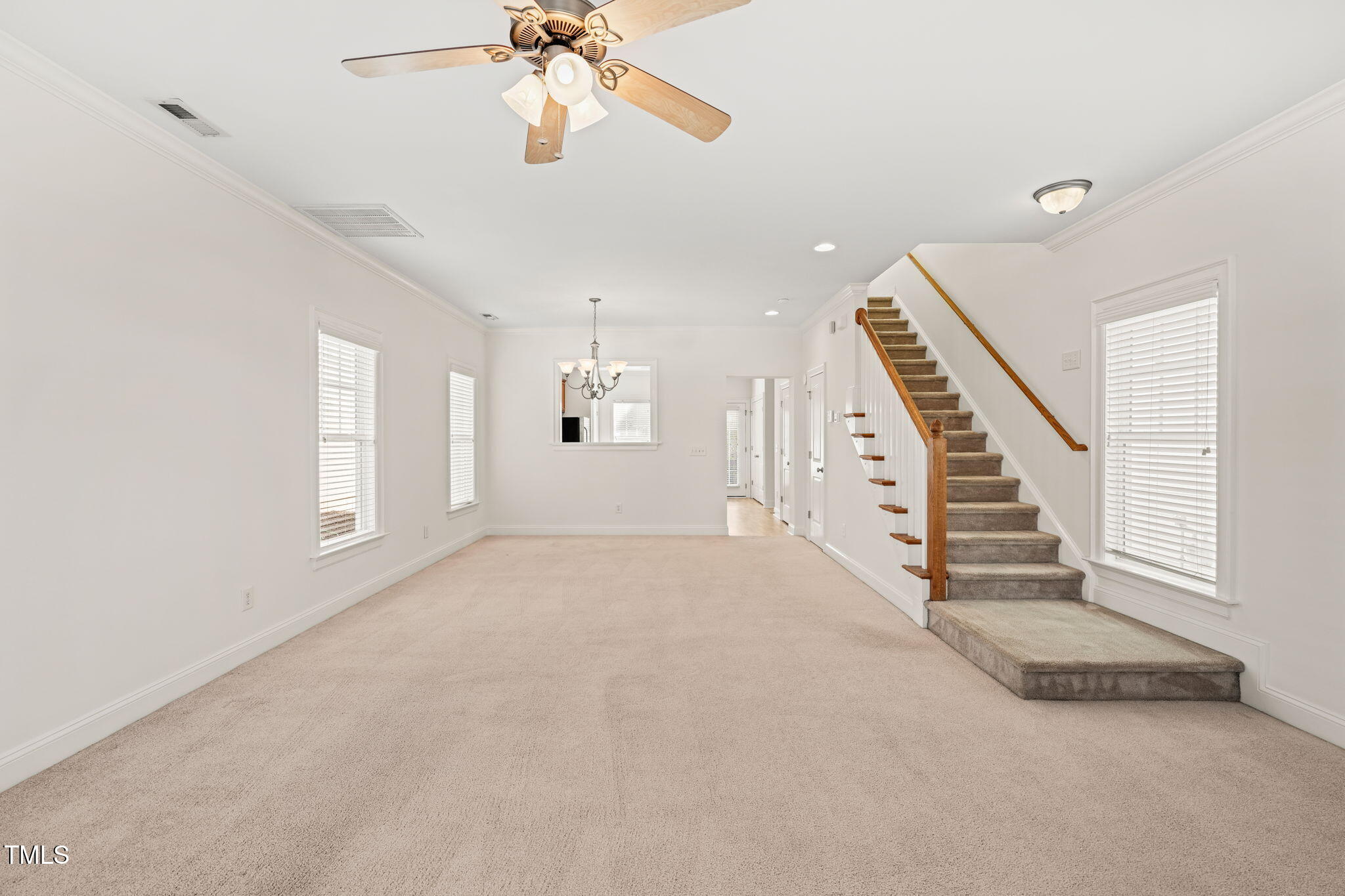 7732 ACC Boulevard Raleigh, NC 27617 - Photo 17 of 32 en view interior of a house with stairs and chandelier fan