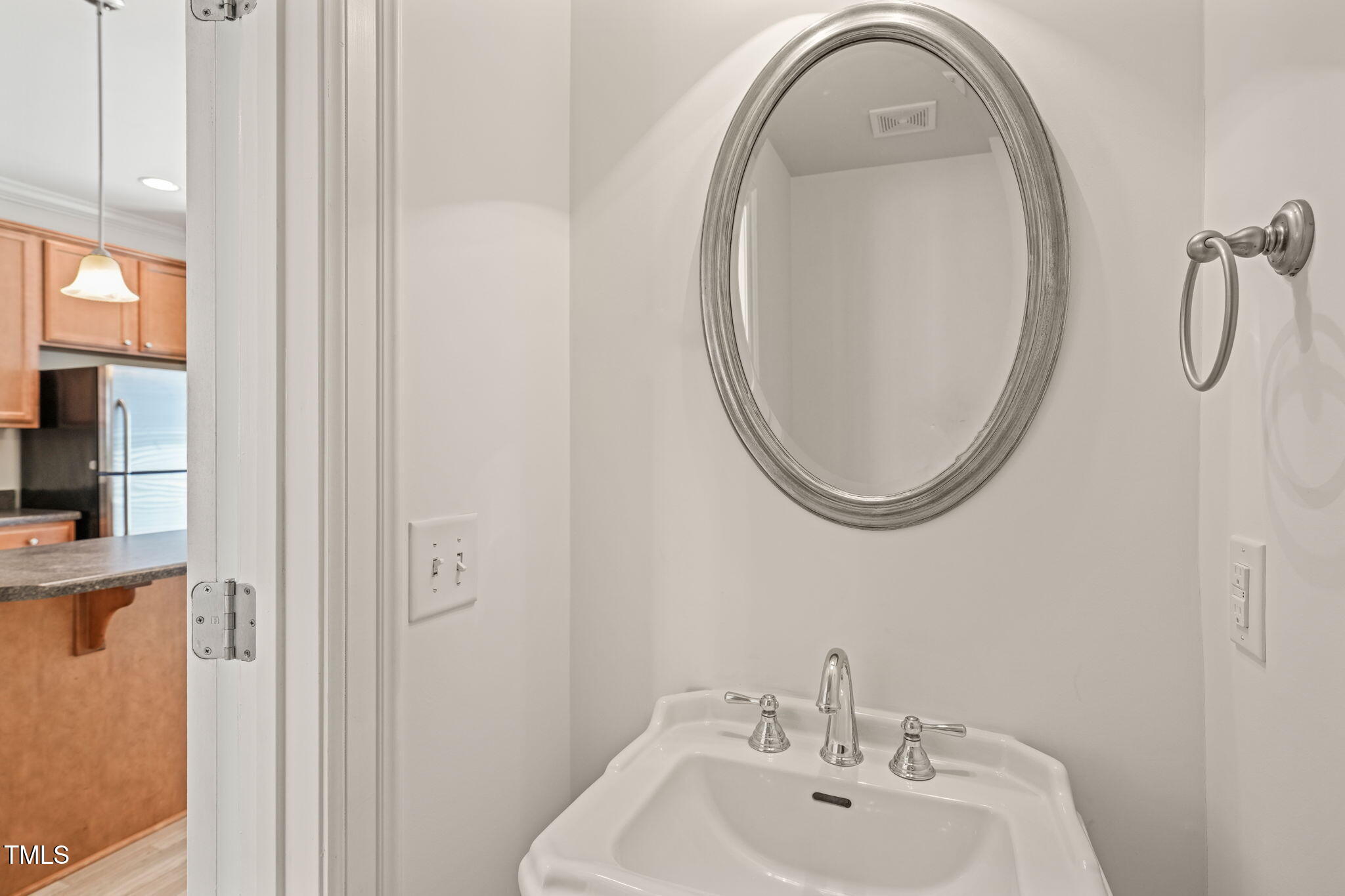 7732 ACC Boulevard Raleigh, NC 27617 - Photo 19 of 32 a bathroom with a sink and a mirror