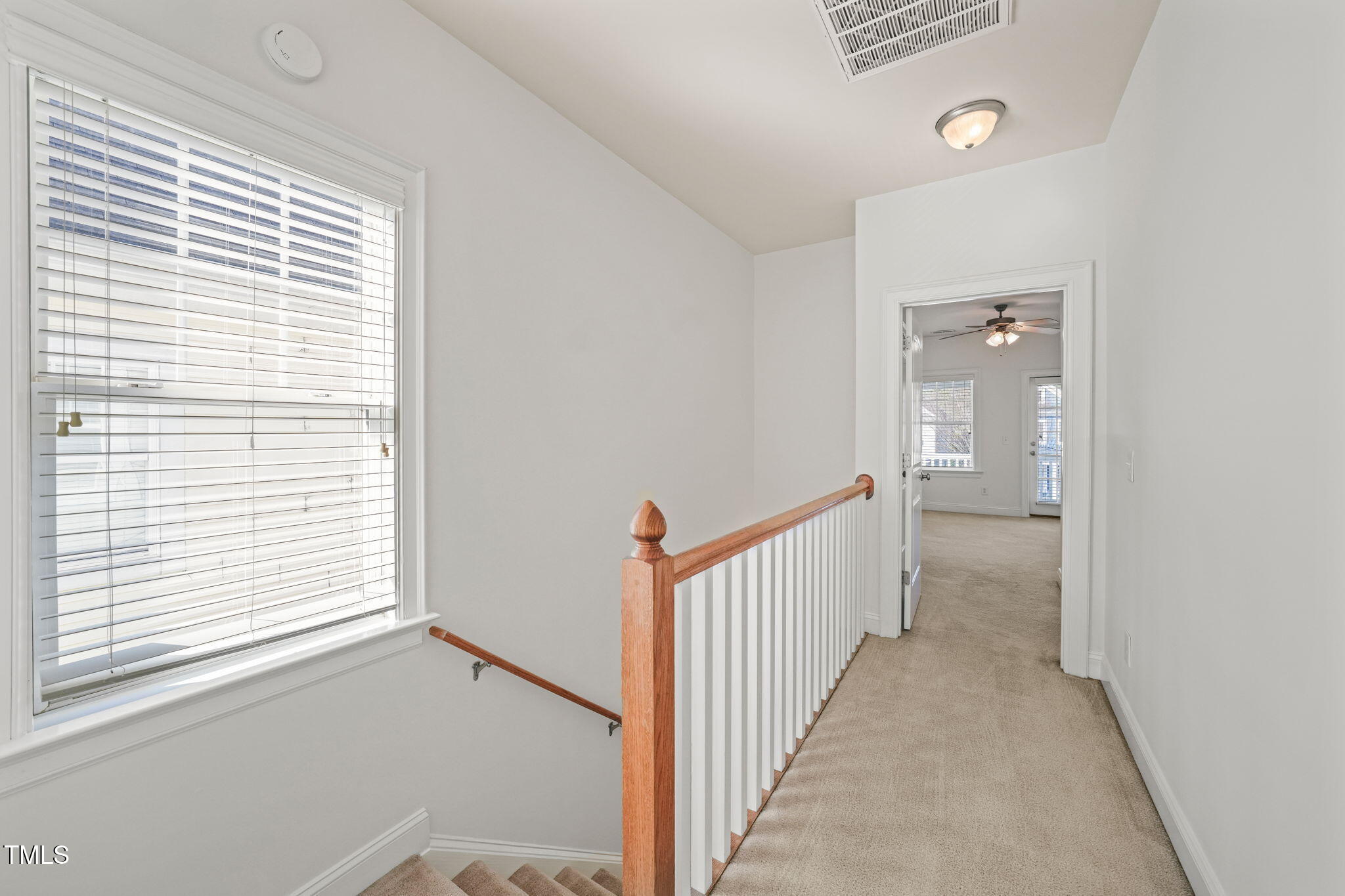 7732 ACC Boulevard Raleigh, NC 27617 - Photo 20 of 32 a view of a hallway with a window and stairs