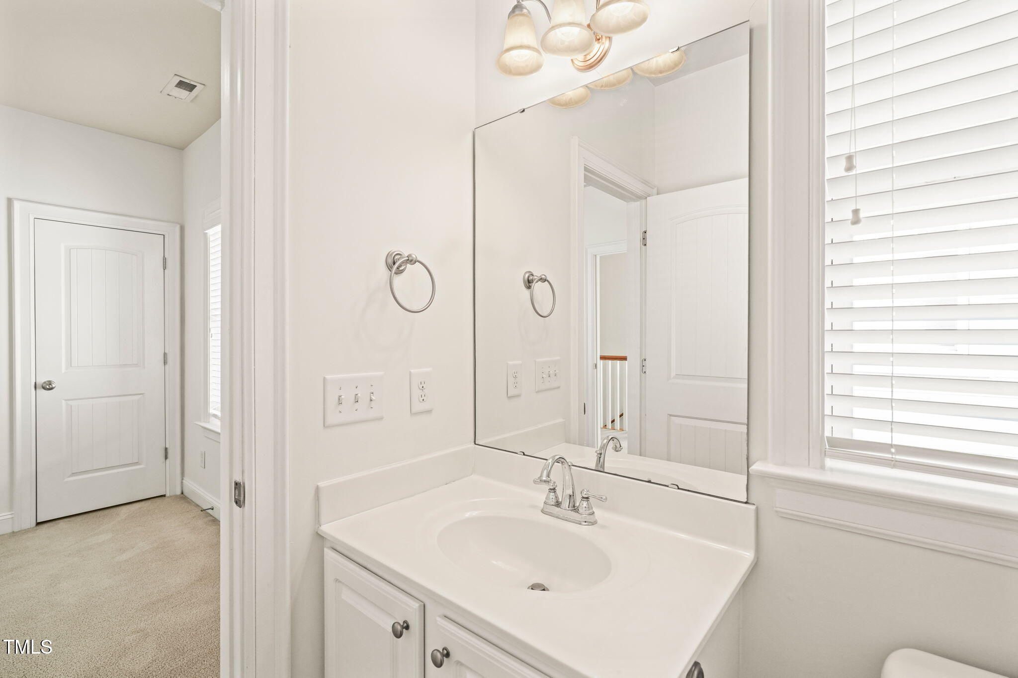 7732 ACC Boulevard Raleigh, NC 27617 - Photo 24 of 32 a bathroom with a sink a mirror and a shower