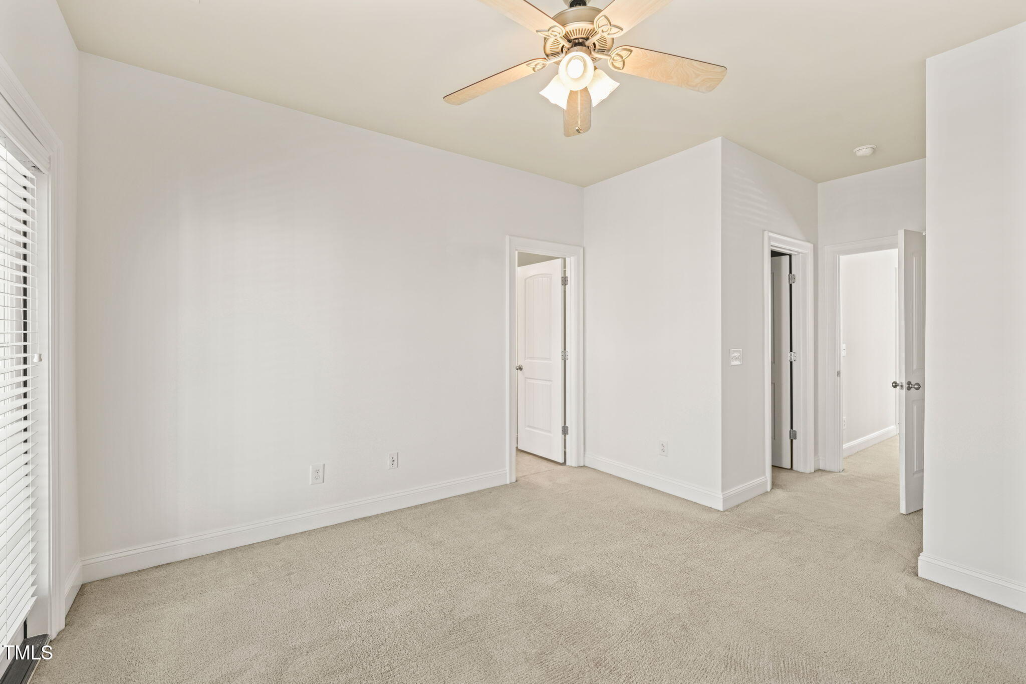 7732 ACC Boulevard Raleigh, NC 27617 - Photo 27 of 32 an empty room with a chandelier fan and closet area