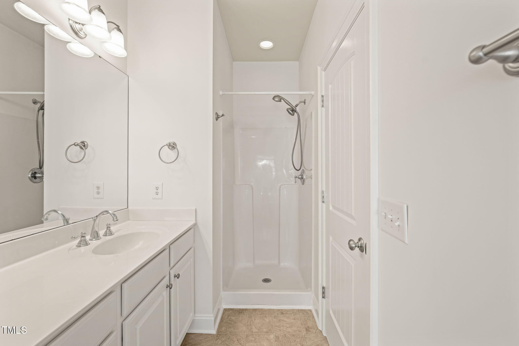 7732 ACC Boulevard Raleigh, NC 27617 - Photo 28 of 32 a bathroom with a double vanity sink mirror and shower