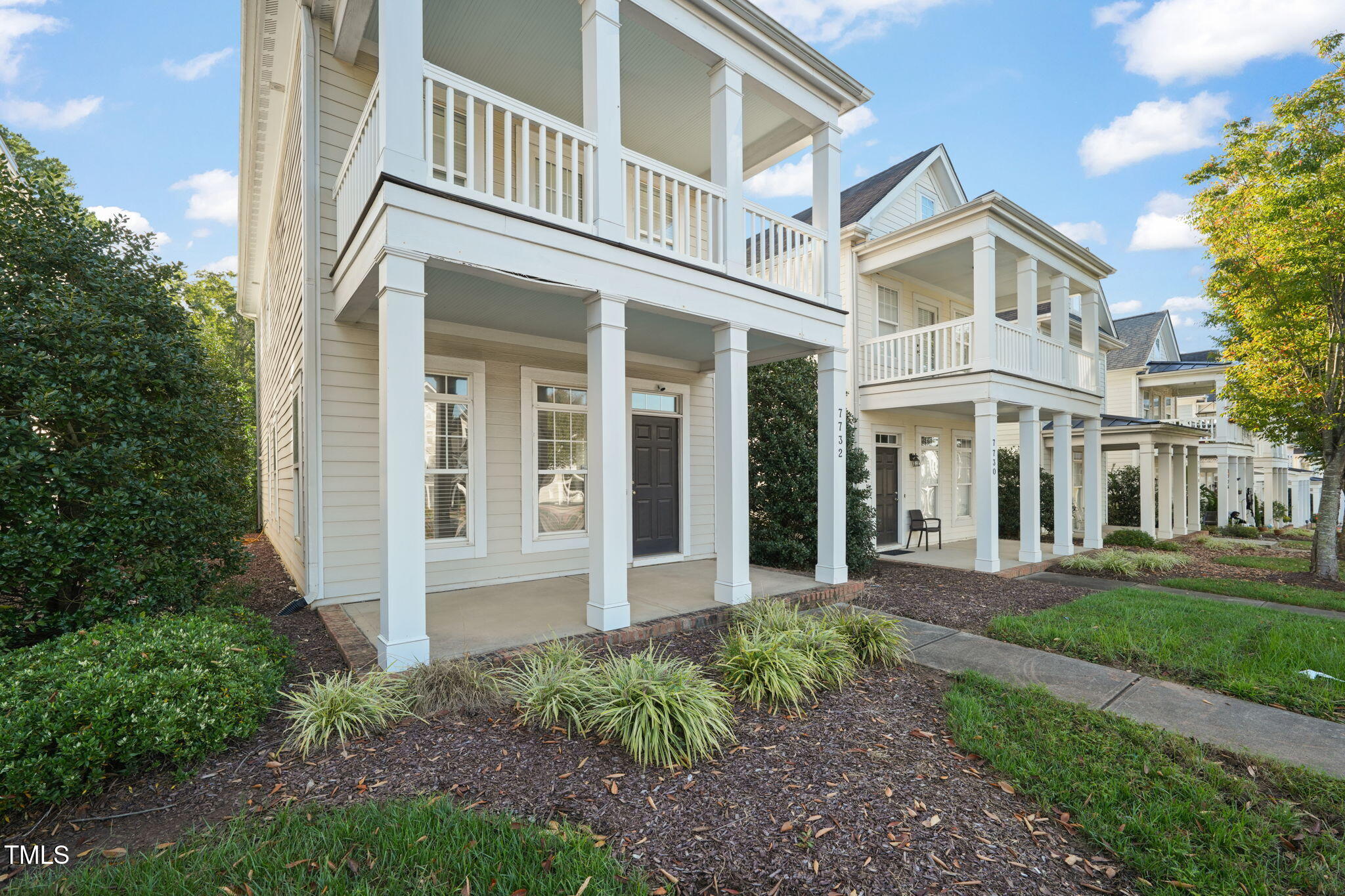 7732 ACC Boulevard Raleigh, NC 27617 - Photo 2 of 32 front view of a building with a yard