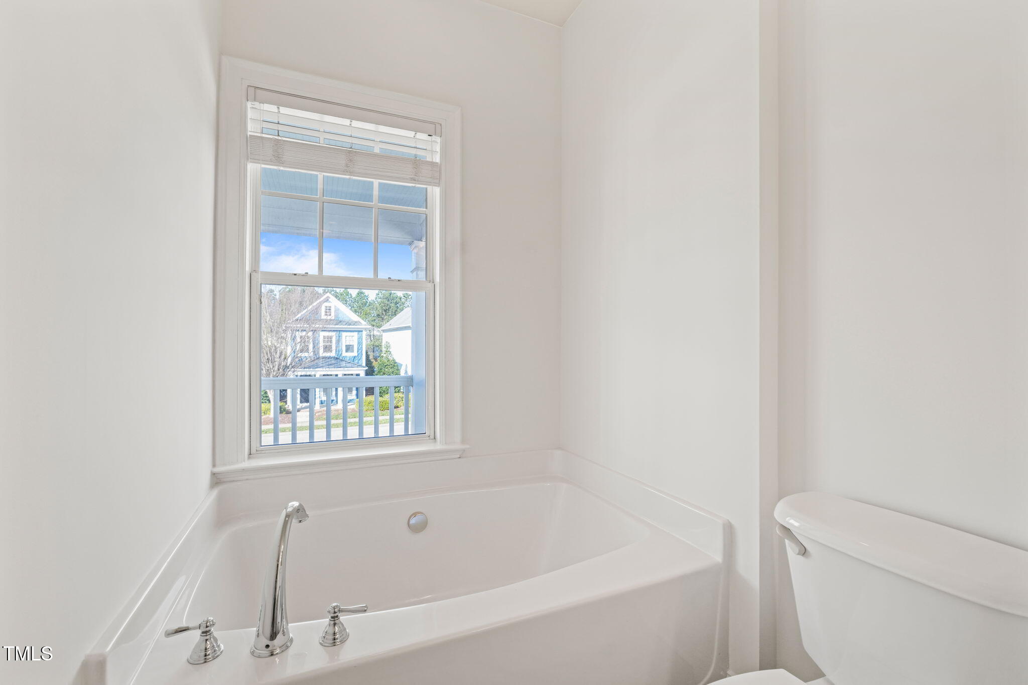 7732 ACC Boulevard Raleigh, NC 27617 - Photo 30 of 32 a white bath tub sitting next to a toilet