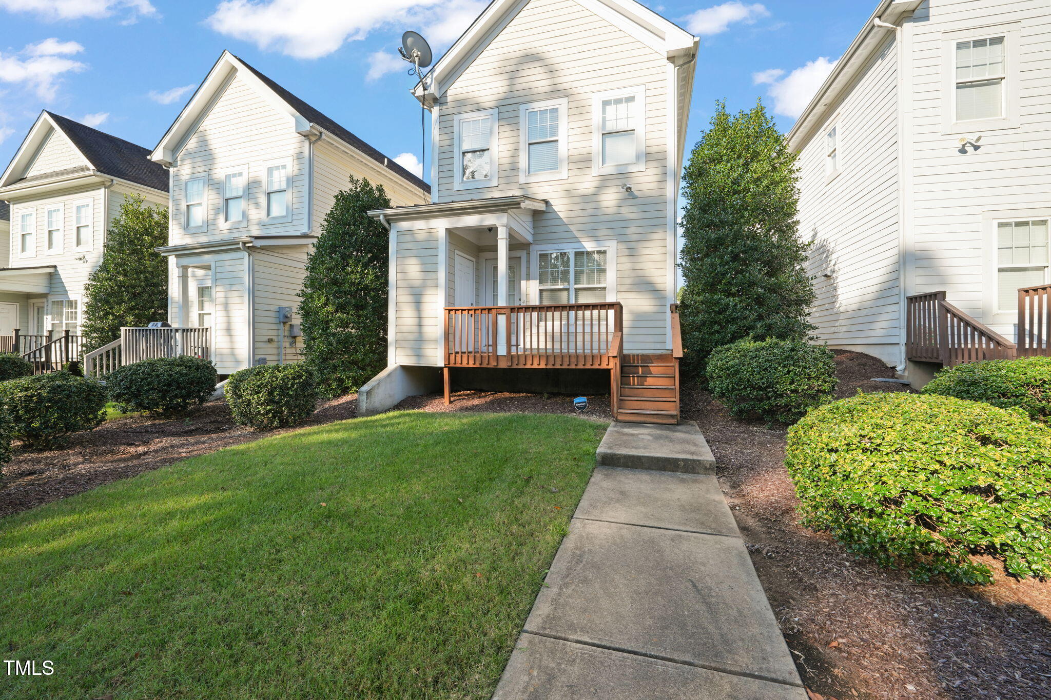 7732 ACC Boulevard Raleigh, NC 27617 - Photo 4 of 32 a front view of a house with a yard