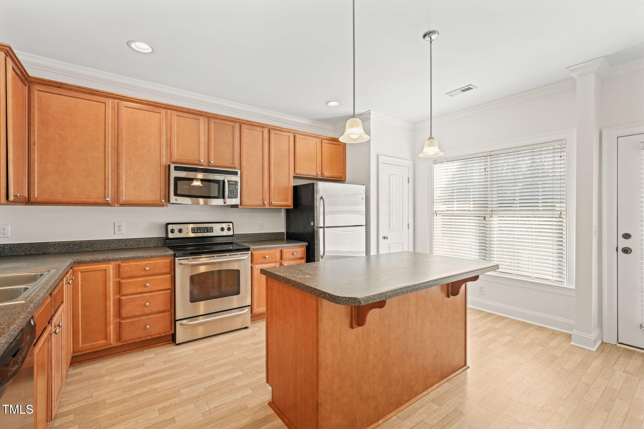 7732 ACC Boulevard Raleigh, NC 27617 - Photo 5 of 32 a kitchen with stainless steel appliances granite countertop a sink a stove and a refrigerator