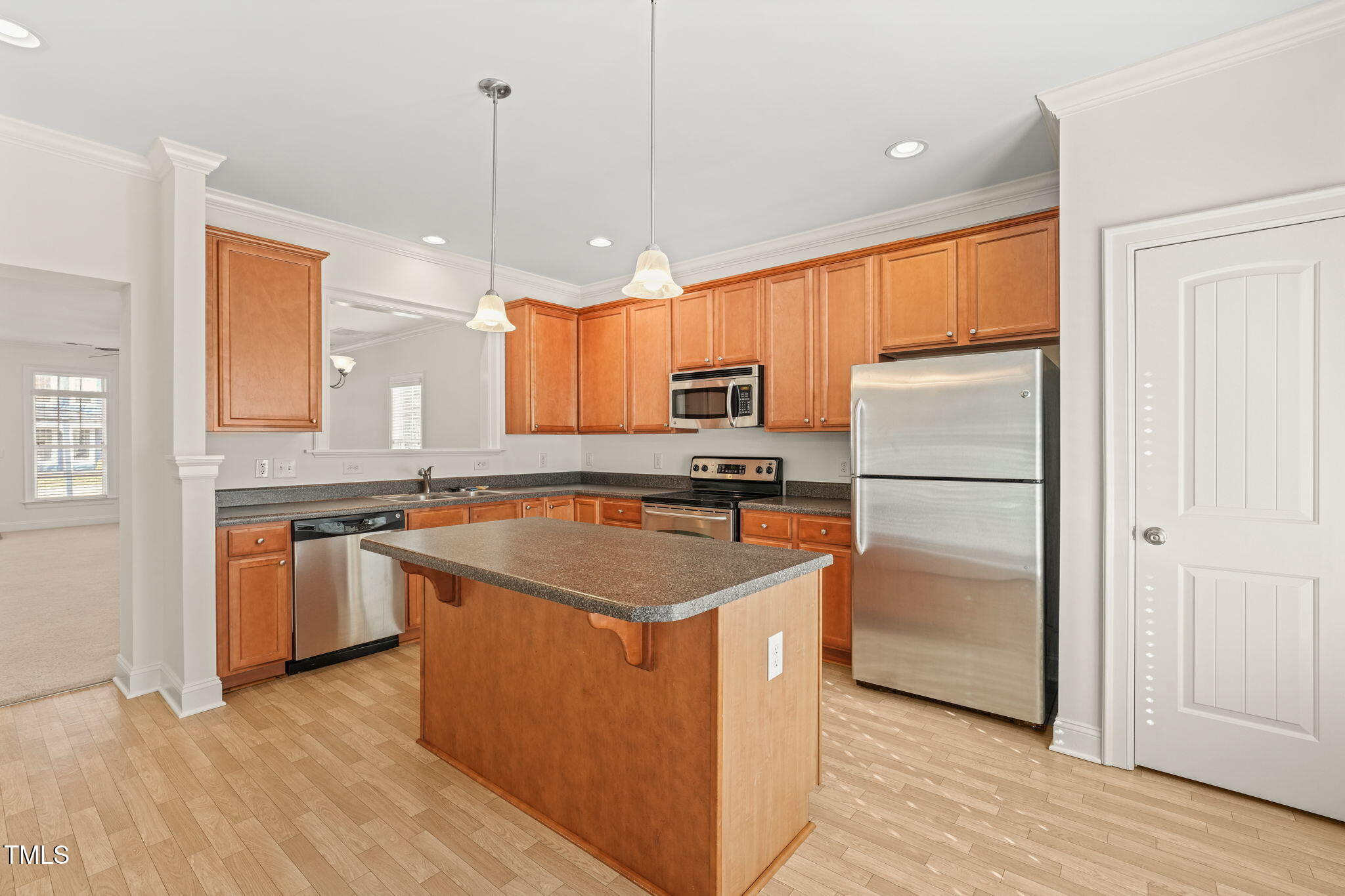 7732 ACC Boulevard Raleigh, NC 27617 - Photo 6 of 32 a kitchen with stainless steel appliances granite countertop a refrigerator a sink dishwasher a oven with white cabinets and wooden floor