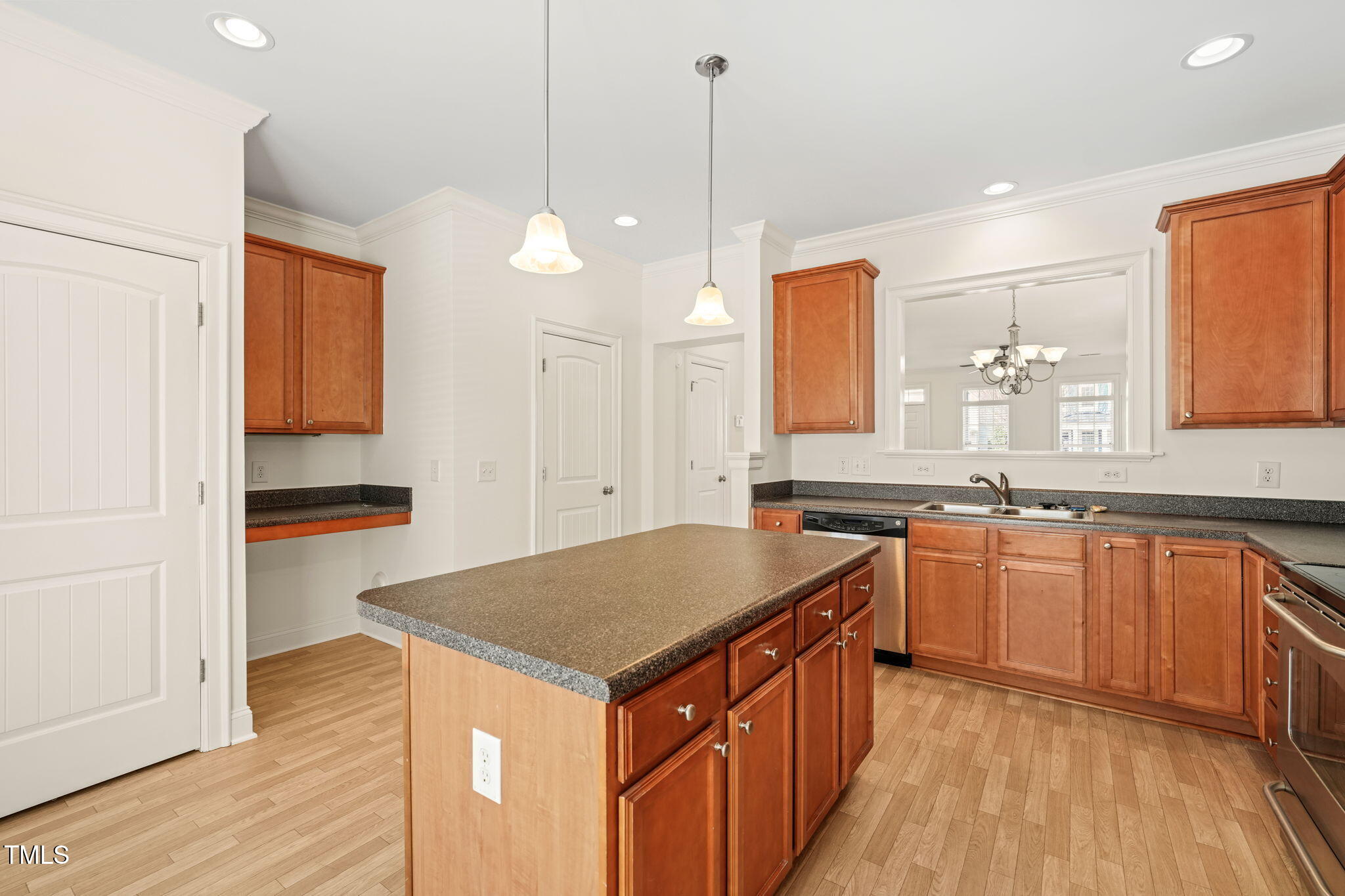 7732 ACC Boulevard Raleigh, NC 27617 - Photo 7 of 32 a kitchen with granite countertop a sink a counter space appliances and cabinets