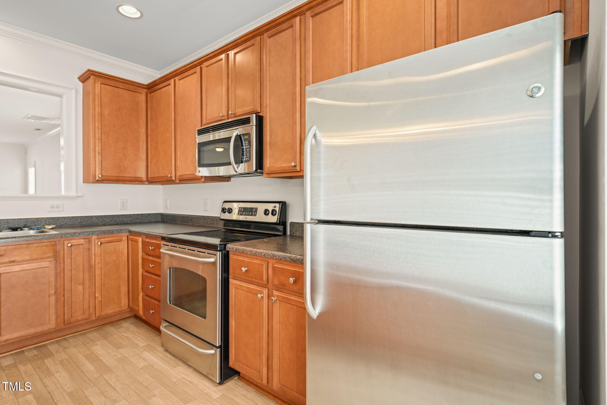 7732 ACC Boulevard Raleigh, NC 27617 - Photo 8 of 32 a kitchen with stainless steel appliances granite countertop a refrigerator and a stove top oven