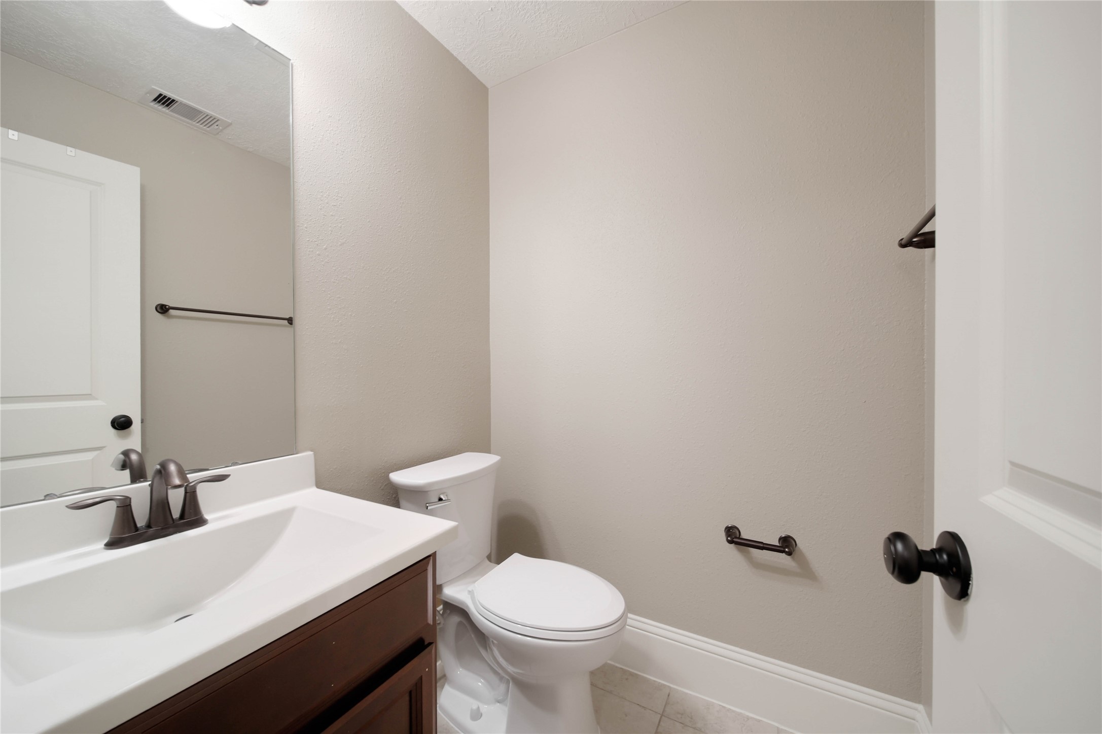 1215 Jake Springs Court Spring, TX 77386 - Photo 30 of 49 A half bath is convenient for long hours spent in the upstairs gameroom.